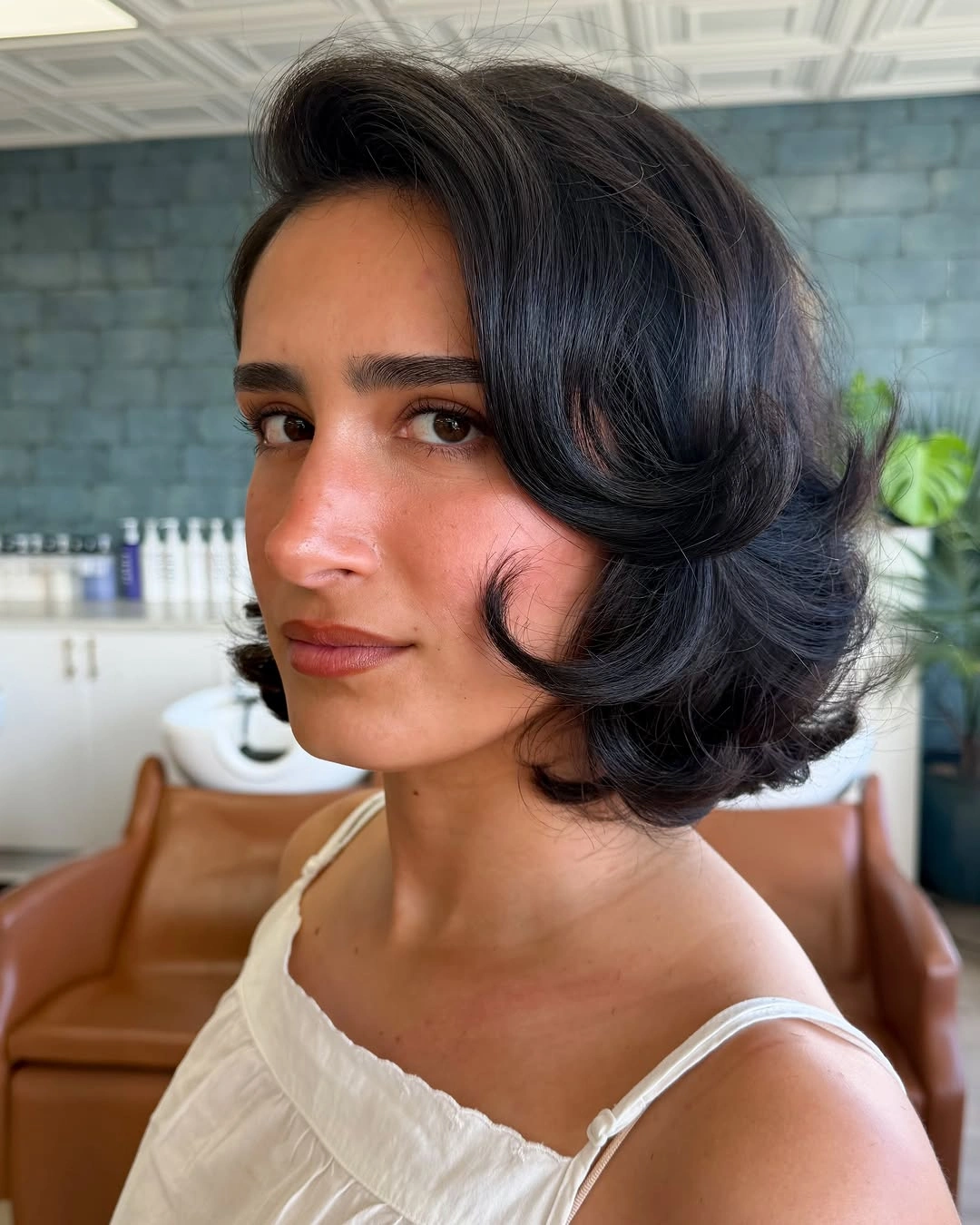 stylish and trendy hairstyles for women over 30 2027 Glossy Dark Curly Bob With Vintage Volume