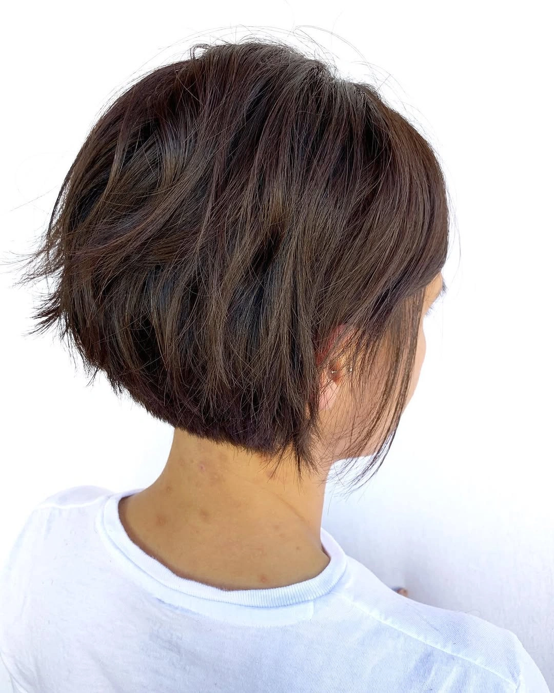 stylish and trendy hairstyles for women over 30 2027 Textured Brunette Bob With Feathered Layers
