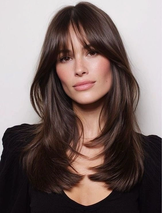 stylish winter haircuts Layered Chocolate Hair With Curtain Bangs