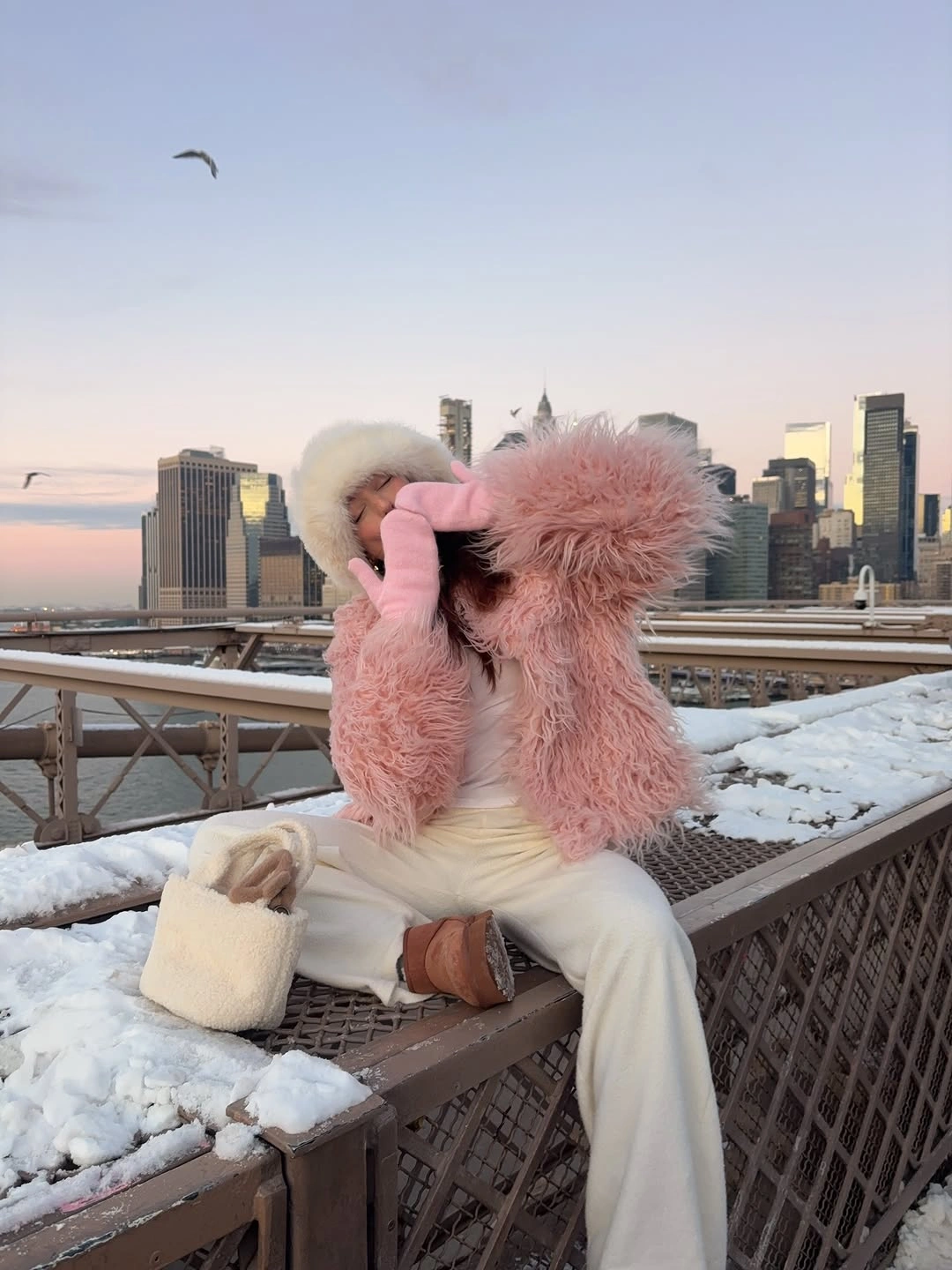 stylish winter NYC outfits - Pink Fur and Cream Layers in the Snow