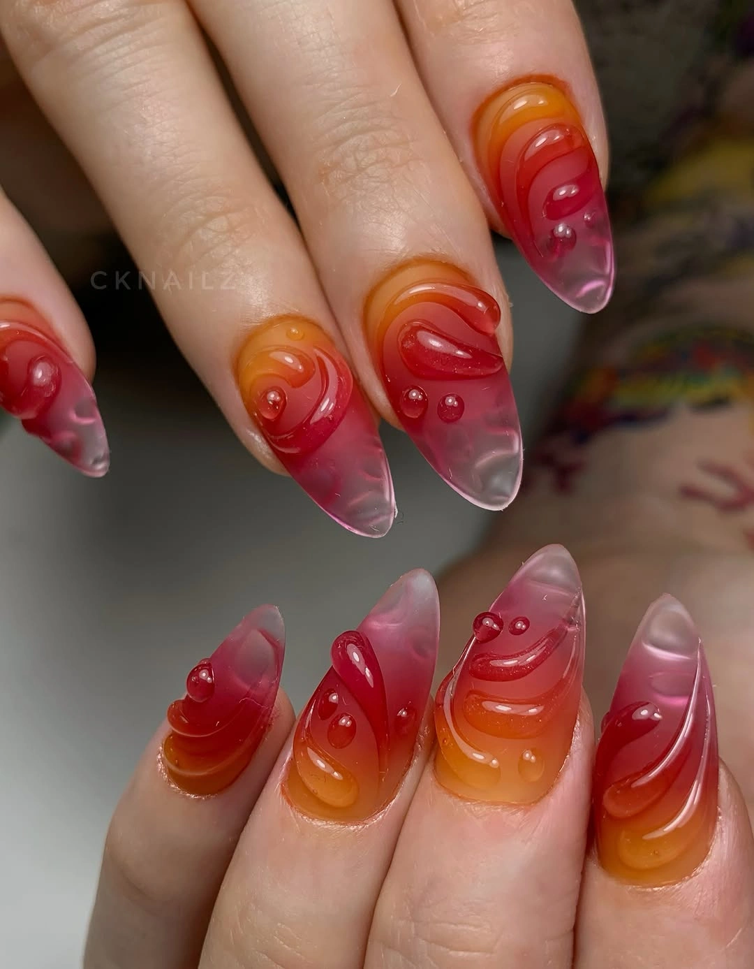 trendy almond nails 2027 - Translucent Red and Orange Jelly Almond Nails