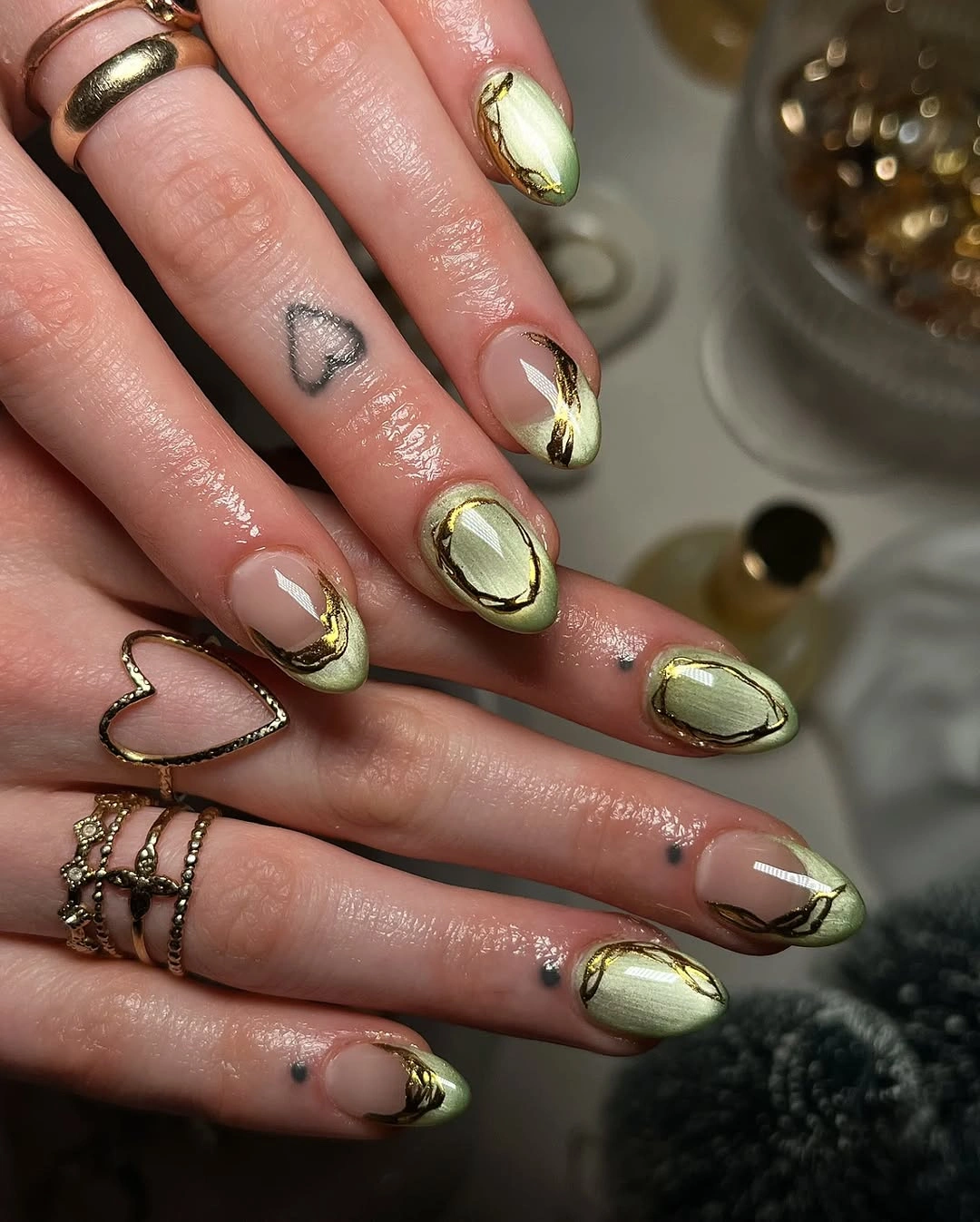 trendy almond nails 2027 - Soft Green Almond Nails With Gold Abstract Accents