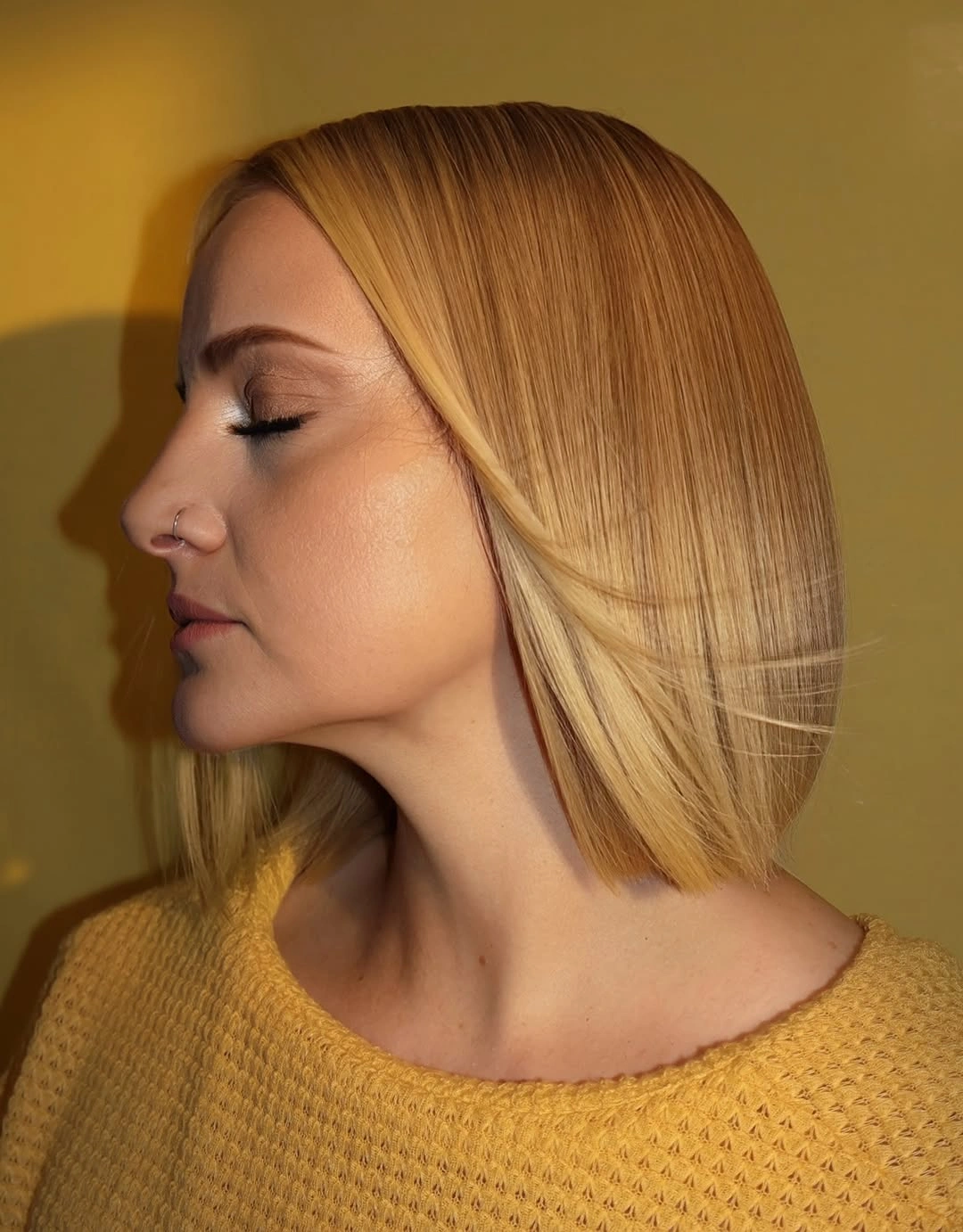 trendy winter hair colors Golden Honey Blonde With a Precision Bob