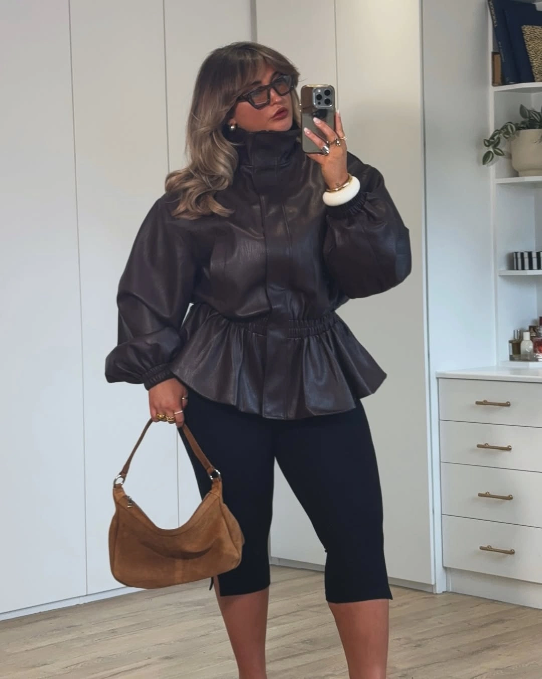 trendy winter outfit for plus size women Leather peplum jacket and black leggings