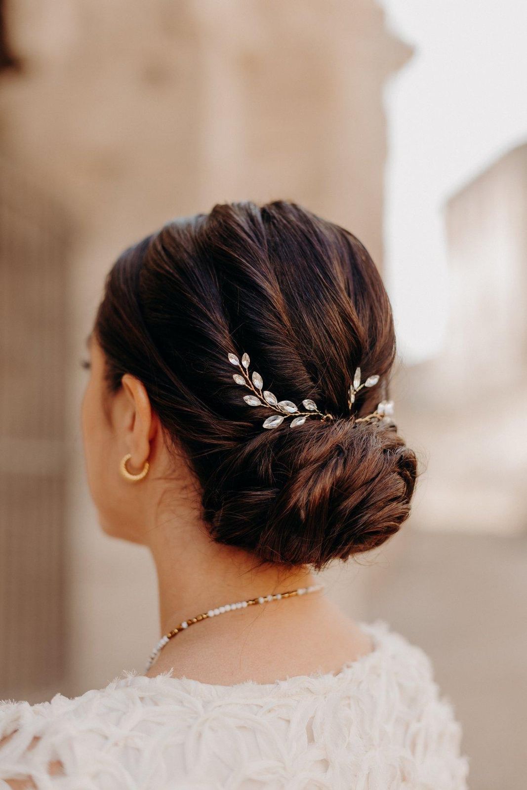 Sleek Dark Brown Low Bun With Sparkle Sleek Dark Brown Low Bun With Sparkle β Winter Wedding Guest Hairstyles