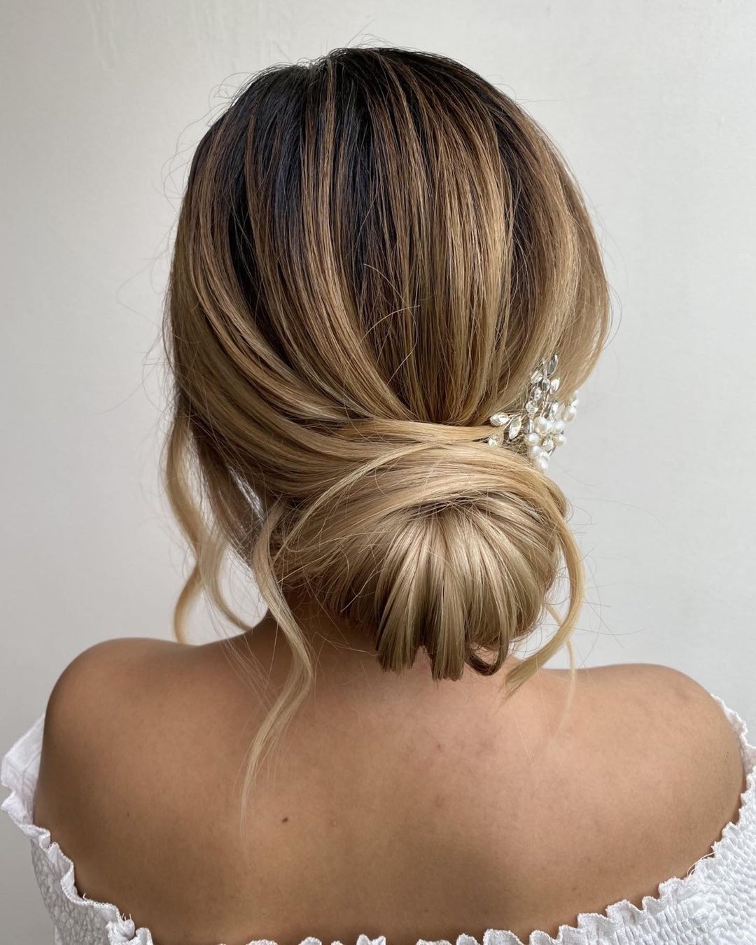 Low Bun With Pearl And Crystal Accessory Low Bun With Pearl And Crystal Accessory β Winter Bun Hairstyles