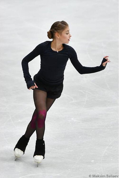 All-Black Athletic Wear with Pink Knee Accents Ice Skating Outfits