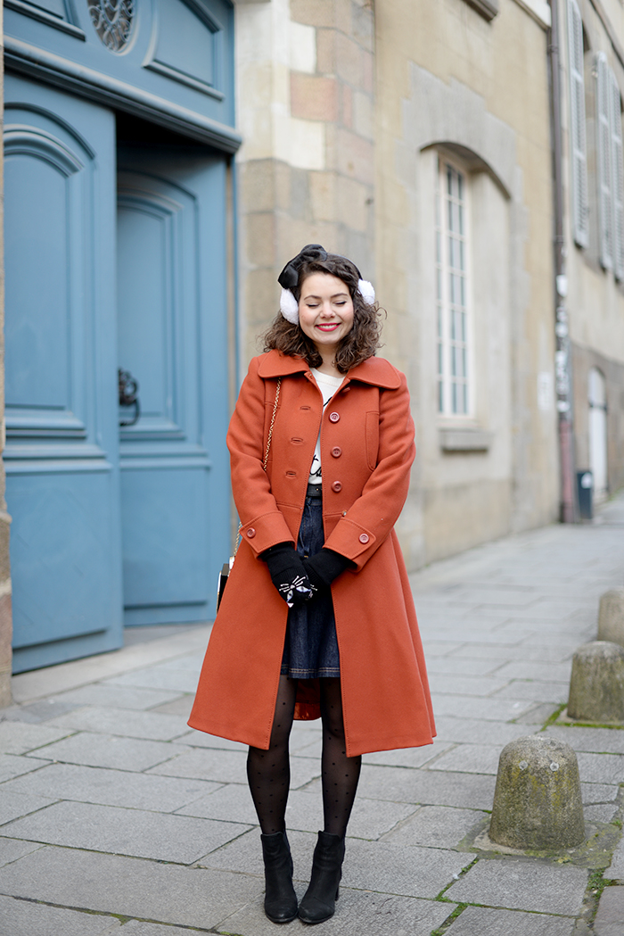 Playful Winter Ensemble: White Earmuffs, Orange Coat, and Denim Skirt — Earmuffs Outfits