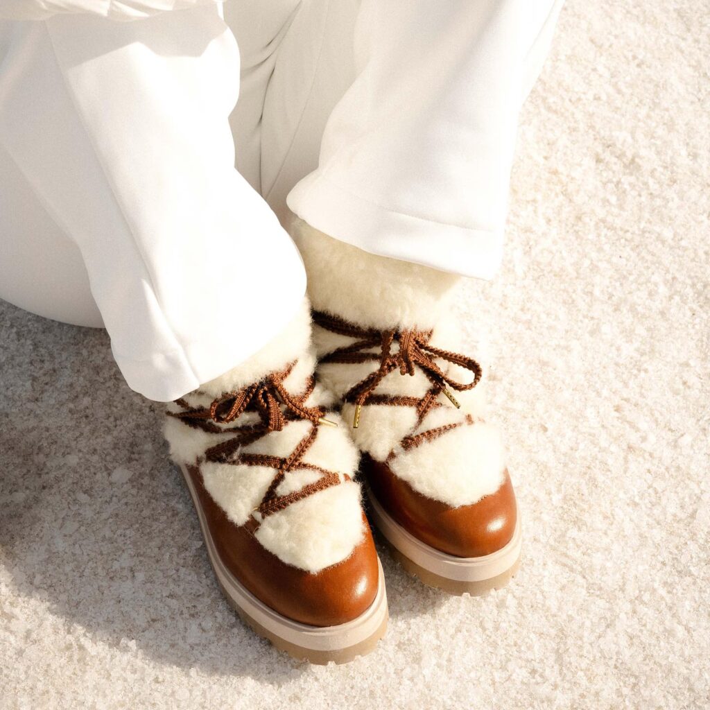 Shearling-Trimmed Lace-Up Boots with White Trousers for Apres Ski — Apres Ski Outfits