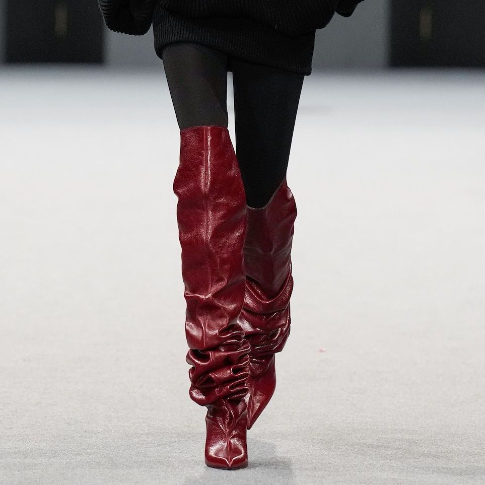 Bold Red Slouchy Boots in a Fashion Show Setting Bold Red Slouchy Boots in a Fashion Show Setting β Slouchy Boots Outfits