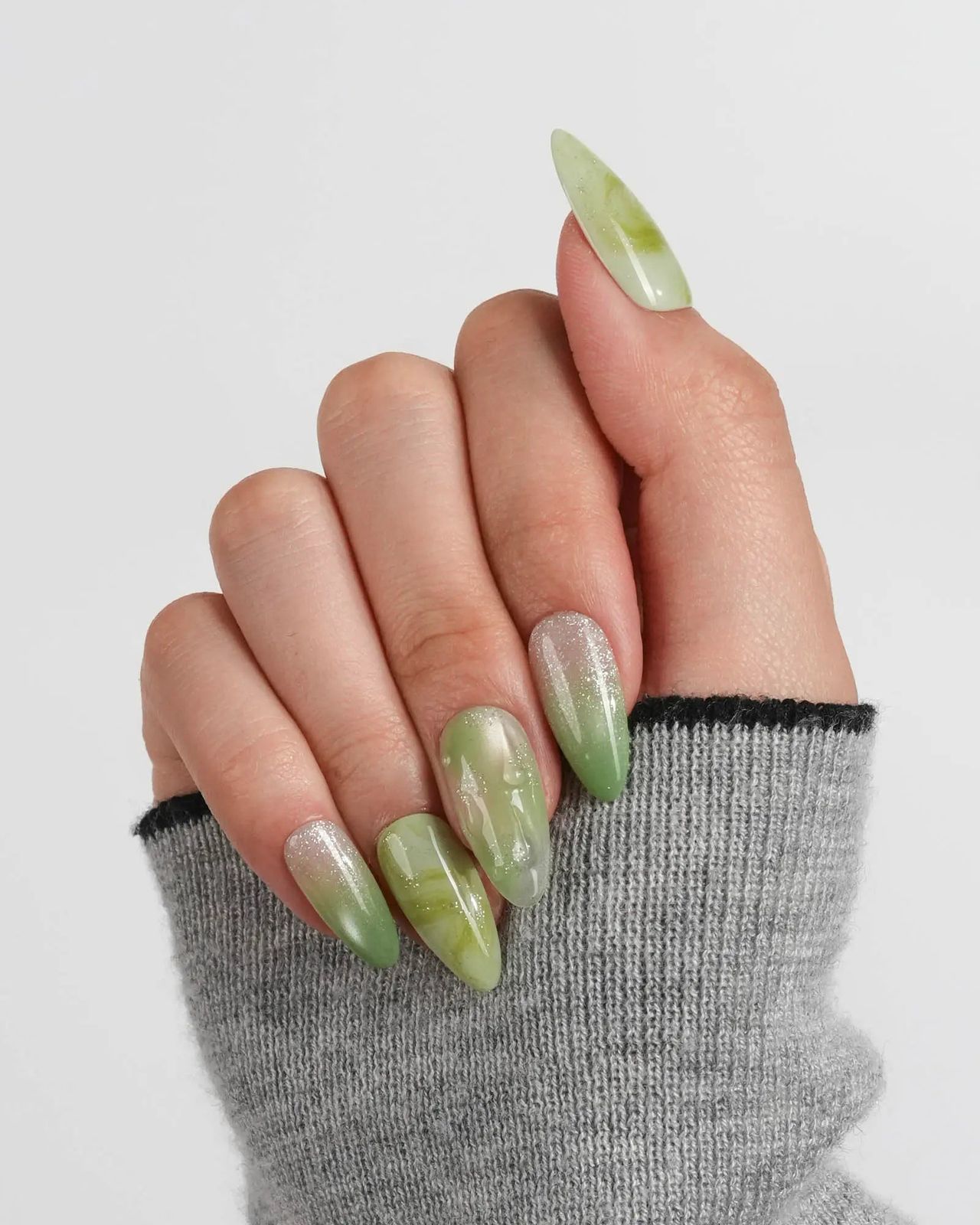 Green Swirls and Glitter Medium Stiletto — Holiday Nail Colors 2026