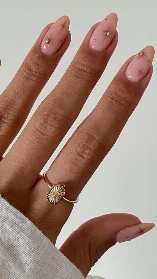 Sheer Pink Gold Star Accent Nails Sheer Pink Gold Star Accent Nails β Minimalist Christmas Nails 2026
