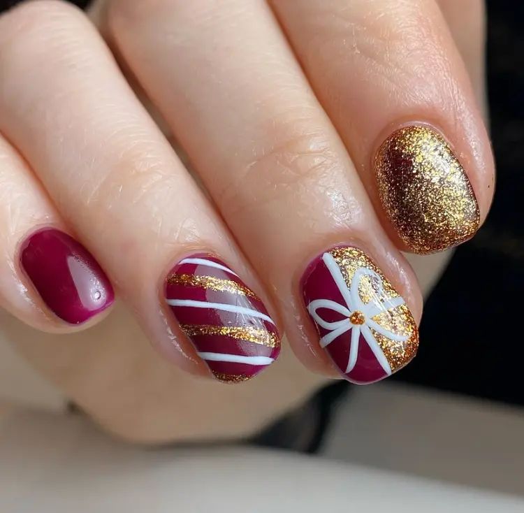 Deep Berry Red with Gold Bow Accents Deep Berry Red with Gold Bow Accents β Red and Gold Christmas Nails 2026