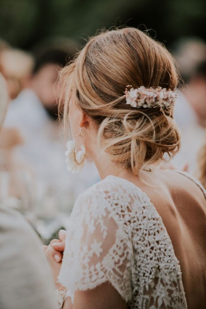 Ash Blonde Loose Messy Bun With Floral Accessory Ash Blonde Loose Messy Bun With Floral Accessory β Winter Formal Hairstyles