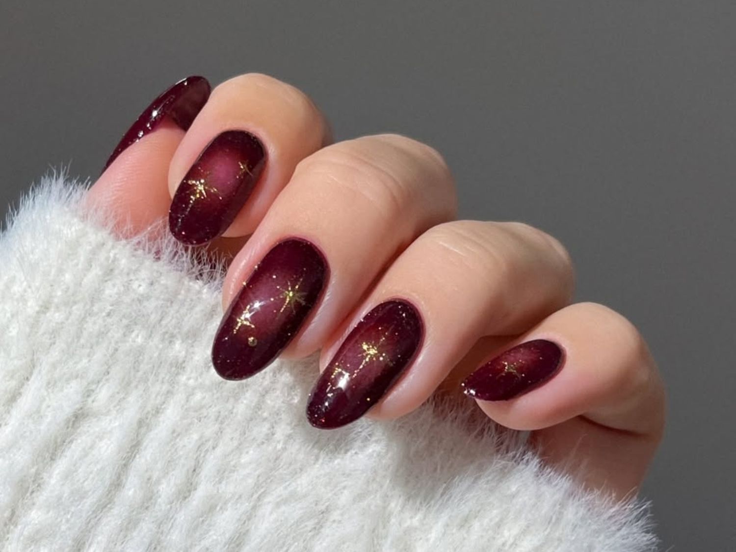 Burgundy Glossy Nails with Gold Constellations Burgundy Glossy Nails with Gold Constellations β Winter Nail Trends