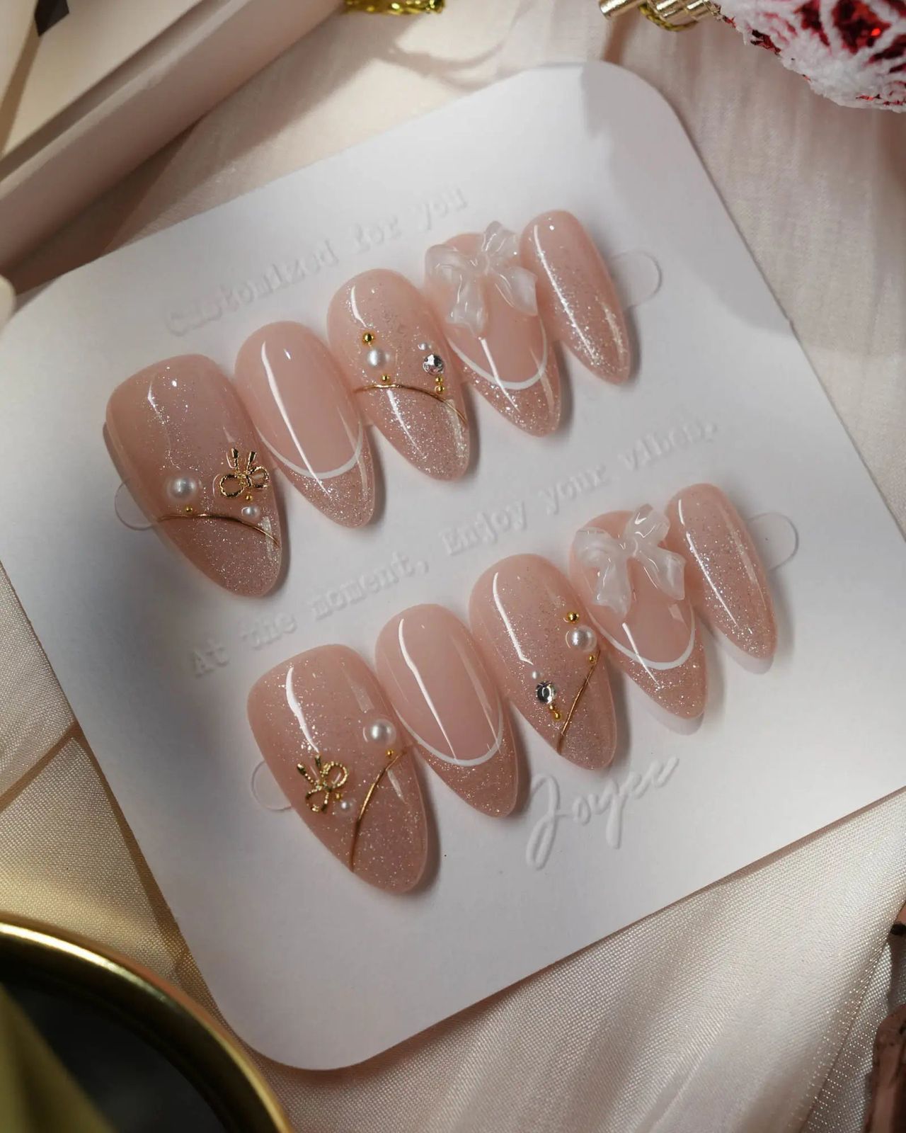 Pinkish-Nude French With Bows And Pearls Pinkish-Nude French With Bows And Pearls β Winter Champagne Nails