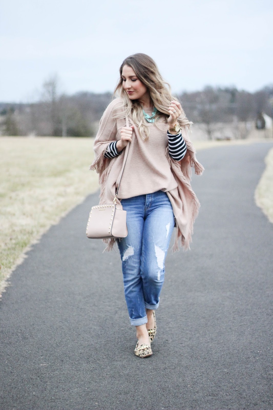 Fringed Poncho Over Striped Shirt and Jeans Fringed Poncho Over Striped Shirt and Jeans β Winter to Spring Transition Outfits