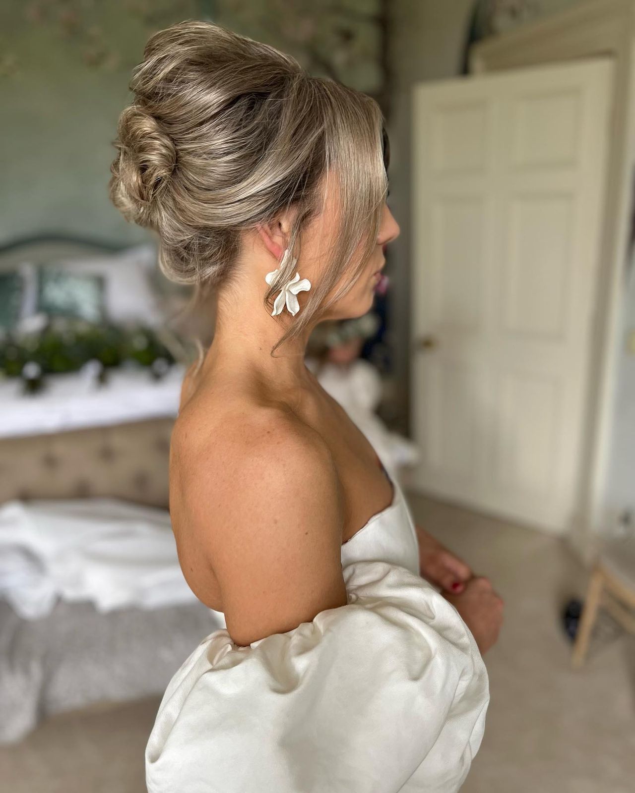 Blonde Twisted Updo With Face-Framing Pieces Blonde Twisted Updo With Face-Framing Pieces β Winter Wedding Guest Hairstyles