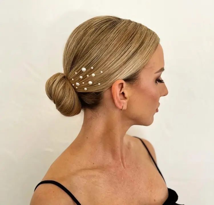 Sleek Blonde Low Bun with Pearls Sleek Blonde Low Bun with Pearls β Winter Party Hairstyles