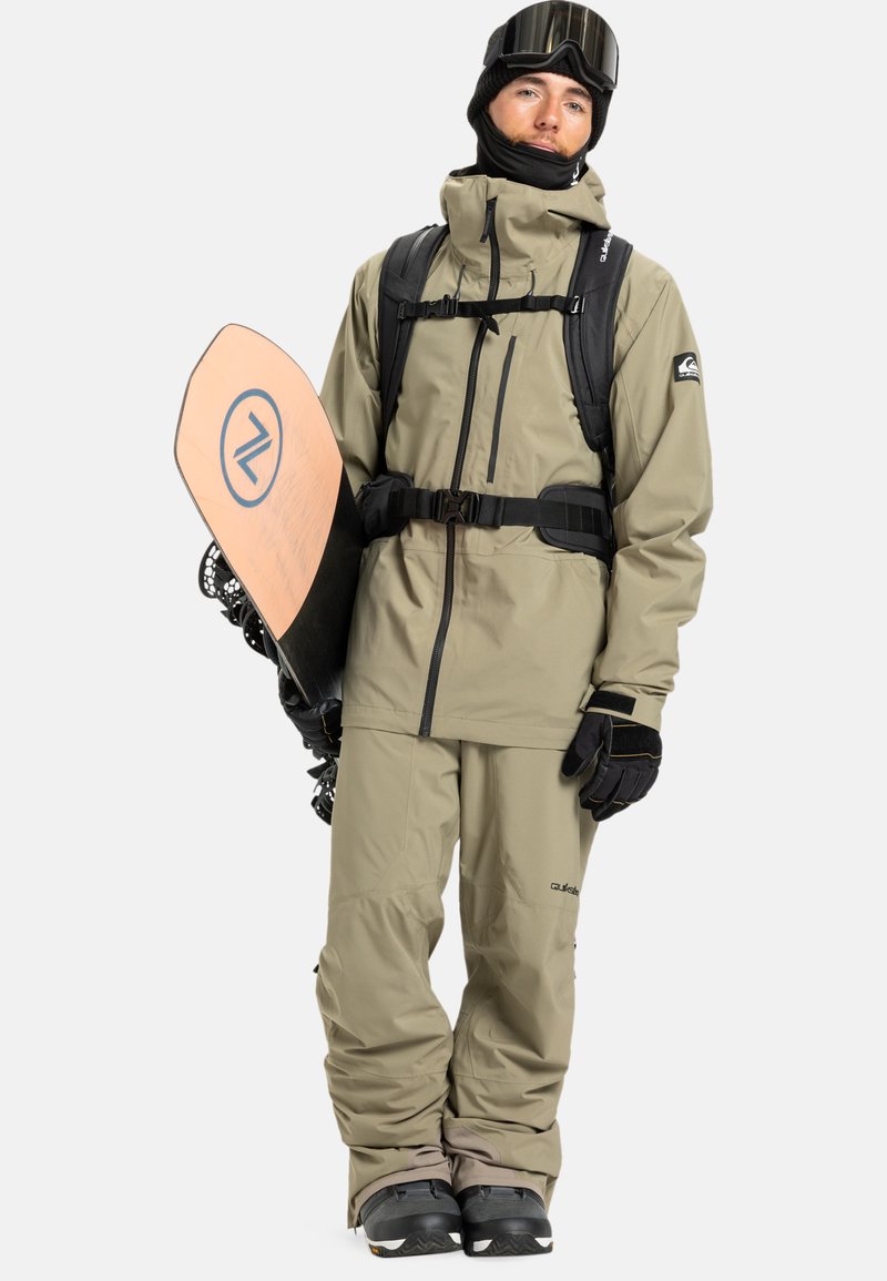 Khaki Hooded Jacket and Pants with Black Accents for a Relaxed Snowboarder Khaki Hooded Jacket and Pants with Black Accents for a Relaxed Snowboarder β Snowboarding Outfits