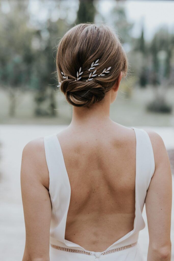 Medium Brown Neat Low Bun With Leaf Pins Medium Brown Neat Low Bun With Leaf Pins β Winter Formal Hairstyles