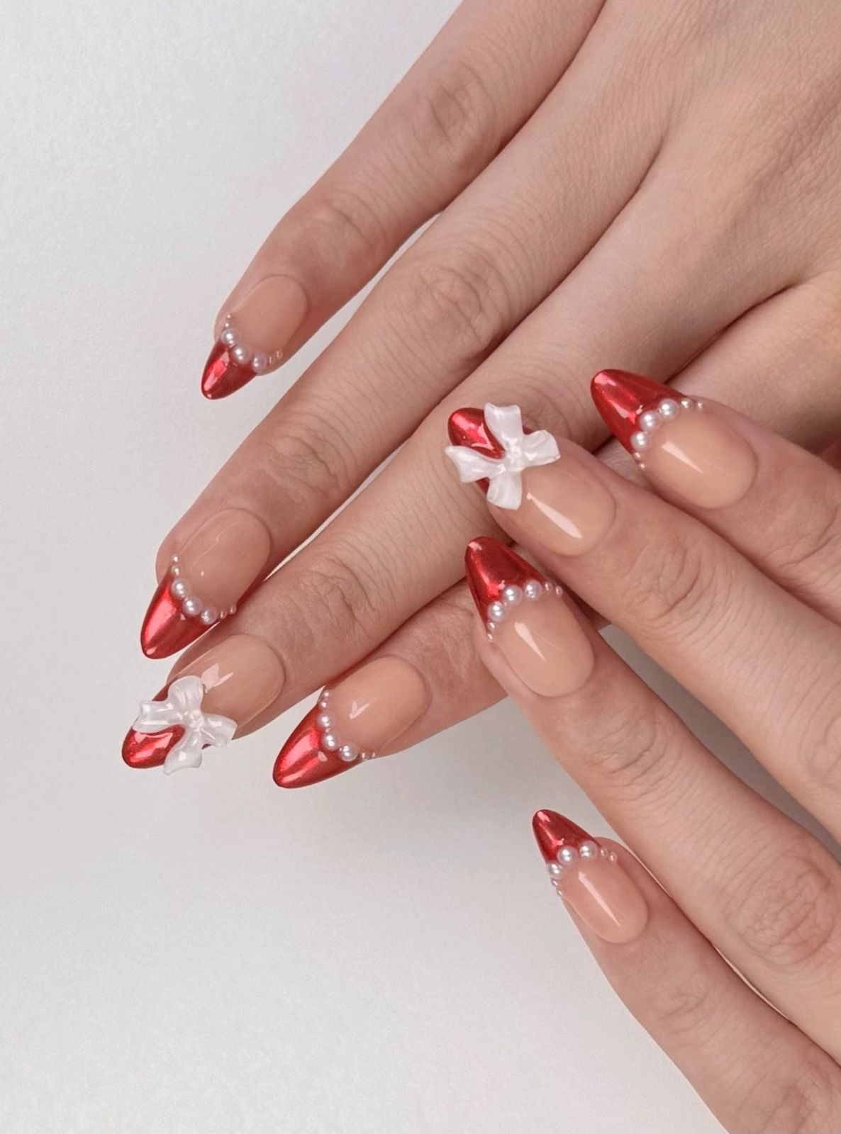 Red Metallic Stiletto Pearl Bow Nails Red Metallic Stiletto Pearl Bow Nails β Classy Christmas Nails 2026