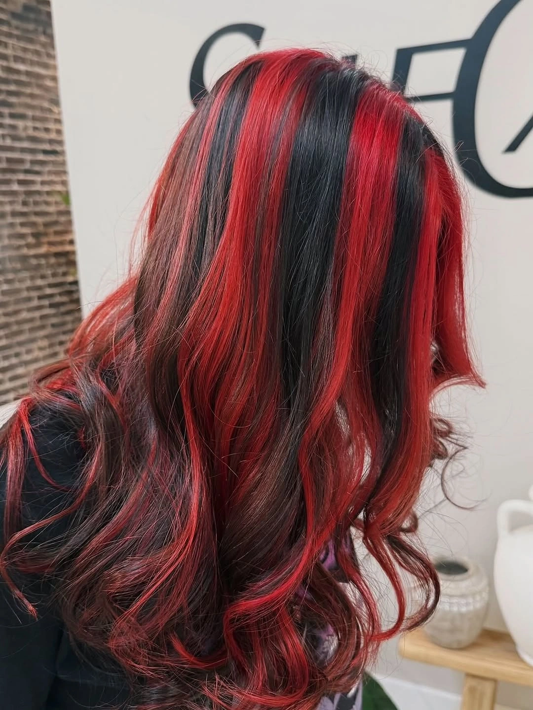 Long wavy hair with vivid scarlet red and black sections Long wavy hair with vivid scarlet red and black sections