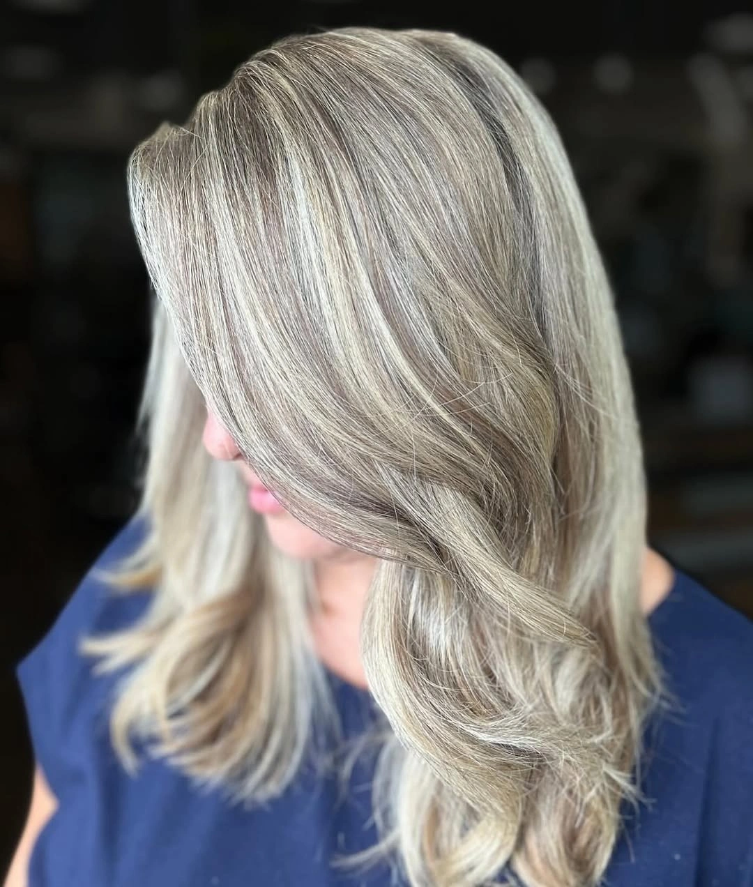 Shoulder-length ash blonde hair with pale silver ribbons and side-swept layers Shoulder-length ash blonde hair with pale silver ribbons and side-swept layers