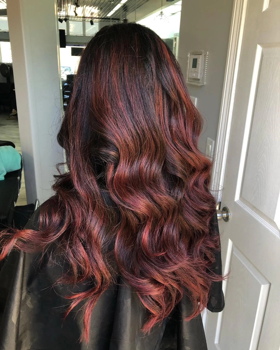 Long reddish brown waves with burgundy and copper red tones Long reddish brown waves with burgundy and copper red tones