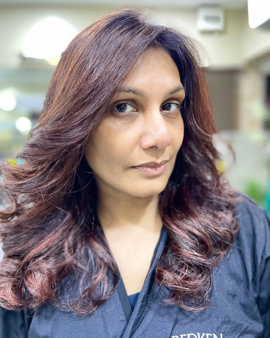Layered reddish brown hair with mahogany tones and curled ends Layered reddish brown hair with mahogany tones and curled ends