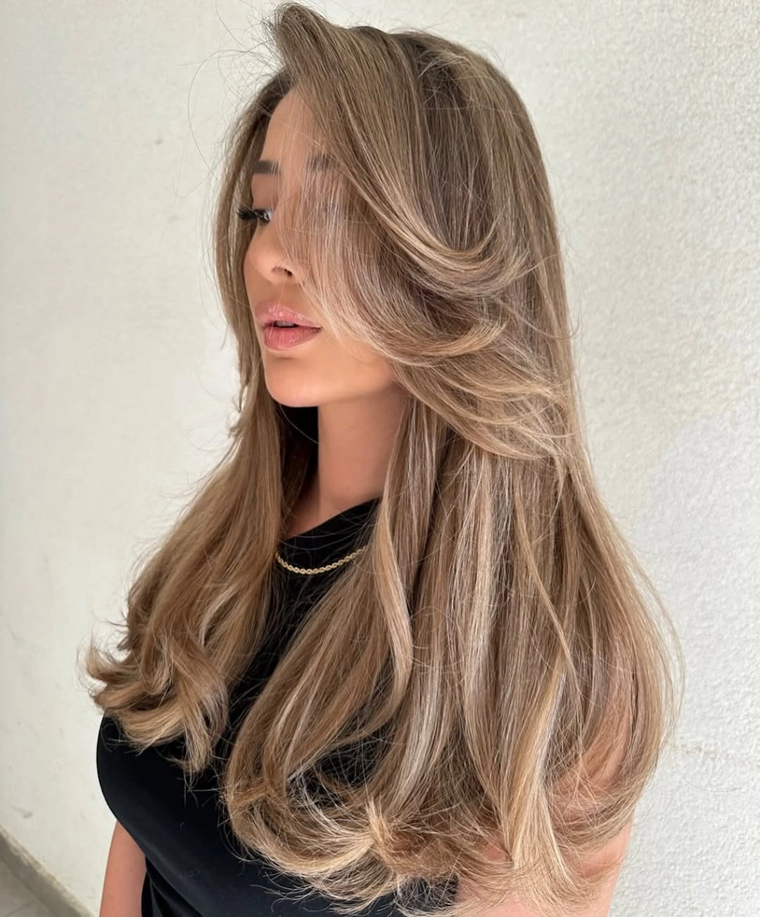 Long layered bronde hair with beige blonde ribbons and sweeping front sections Long layered bronde hair with beige blonde ribbons and sweeping front sections