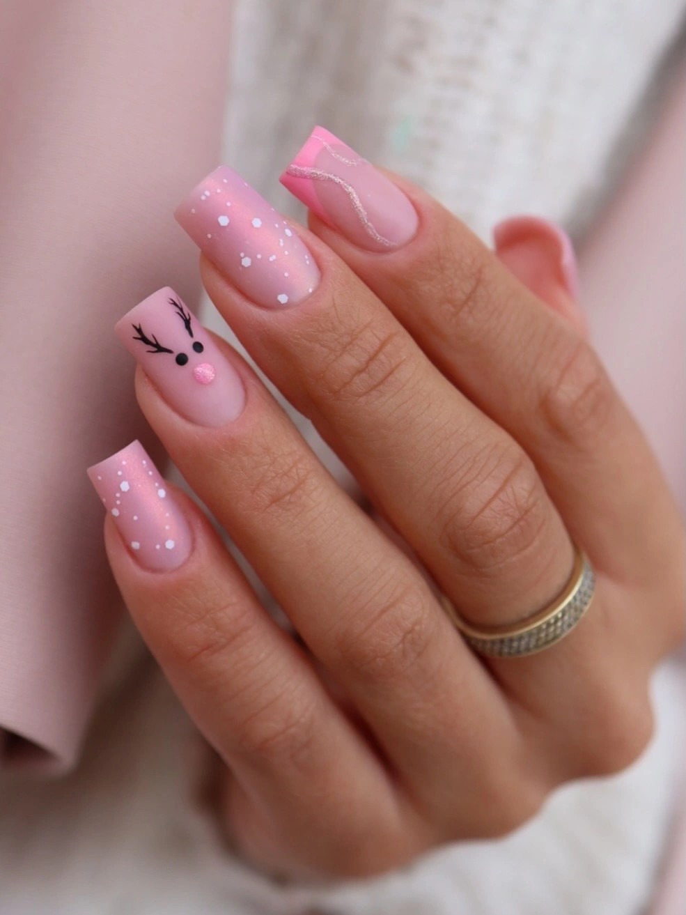 Square pink French nails with white dots and a reindeer face Square pink French nails with white dots and a reindeer face