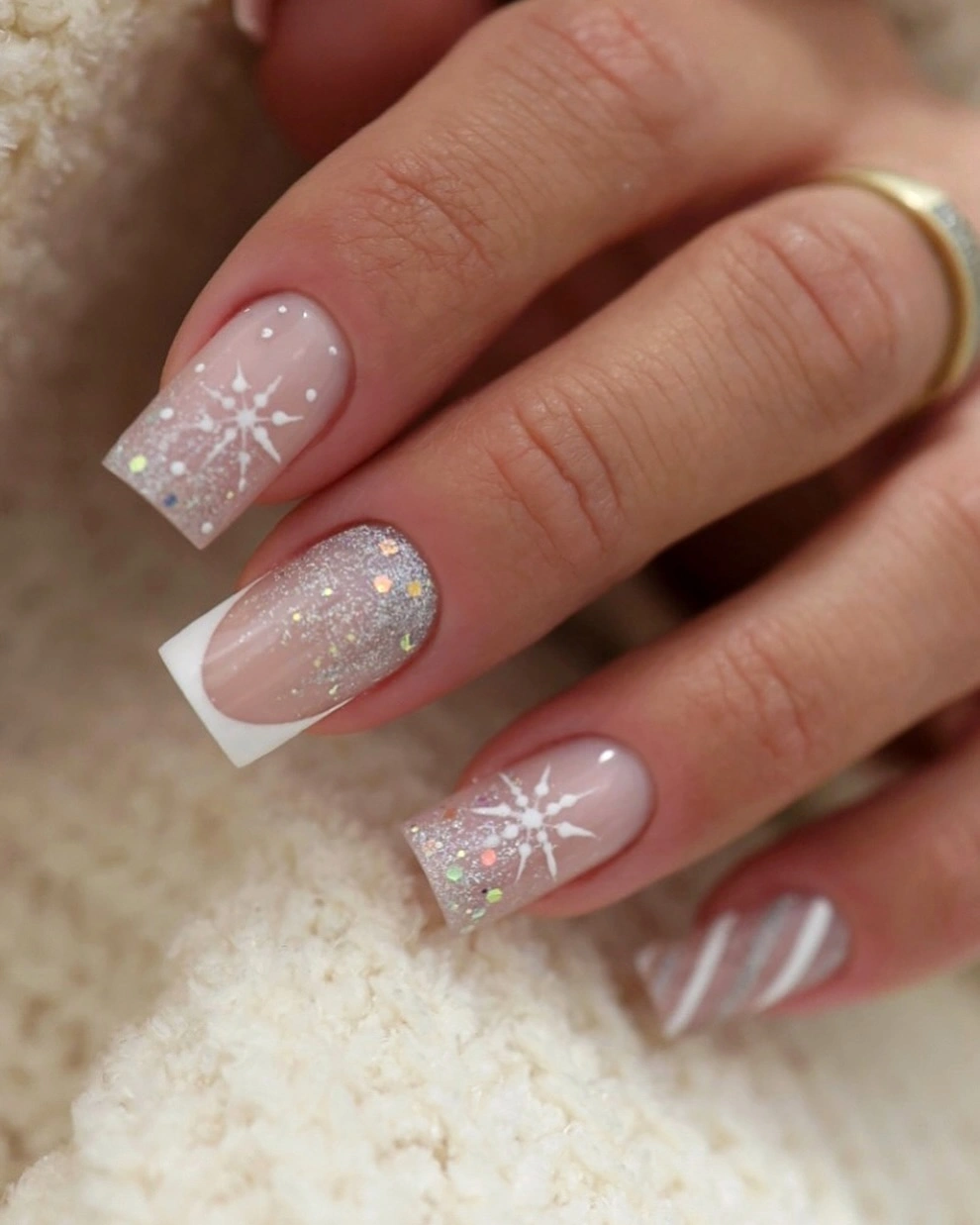 Square nude pink nails with white snowflakes silver shimmer and French tips Square nude pink nails with white snowflakes silver shimmer and French tips