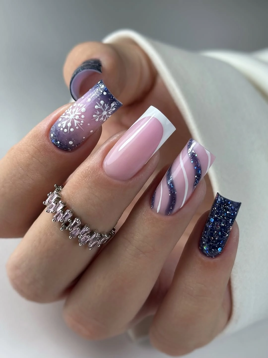 Long square pink nails with blue glitter snowflakes and white French tips Long square pink nails with blue glitter snowflakes and white French tips