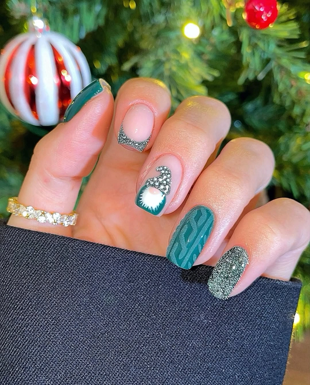 Short teal nails with raised knit pattern silver glitter and ornament detail Short teal nails with raised knit pattern silver glitter and ornament detail