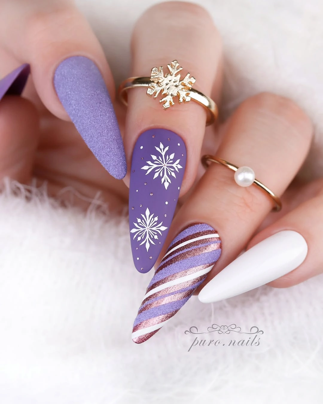 Pointed lavender nails with white snowflakes diagonal stripes and solid white Pointed lavender nails with white snowflakes diagonal stripes and solid white