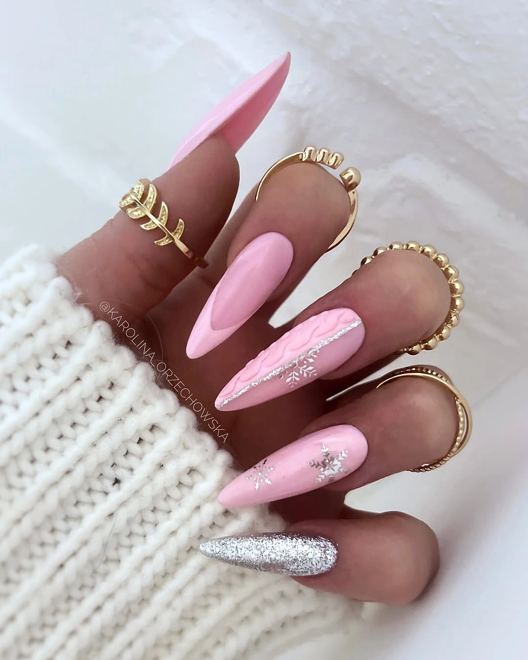 Long pink pointed nails with silver snowflakes knit texture and glitter Long pink pointed nails with silver snowflakes knit texture and glitter