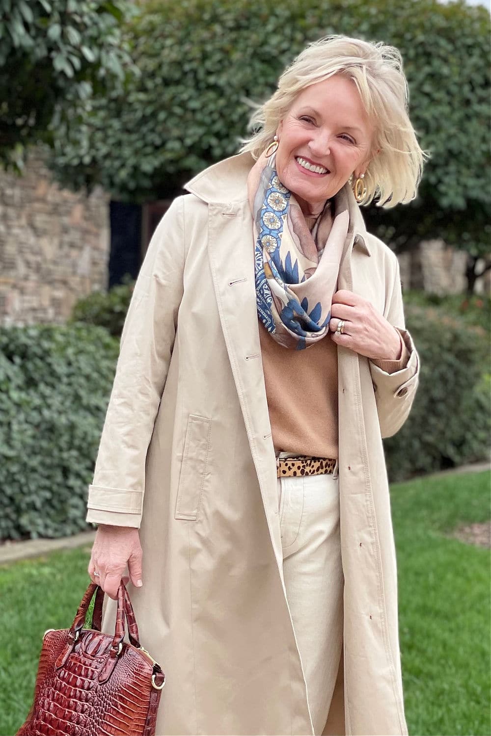 Classic Trench Coat with Brown Sweater and White Pants Classic Trench Coat with Brown Sweater and White Pants β Winter Outfits for Women Over 60