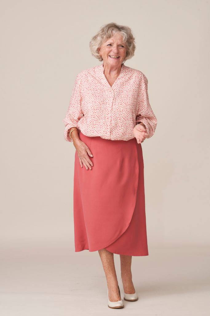 Patterned Blouse Tucked into a Coral Wrap Skirt Patterned Blouse Tucked into a Coral Wrap Skirt β Winter Outfits for Women Over 70