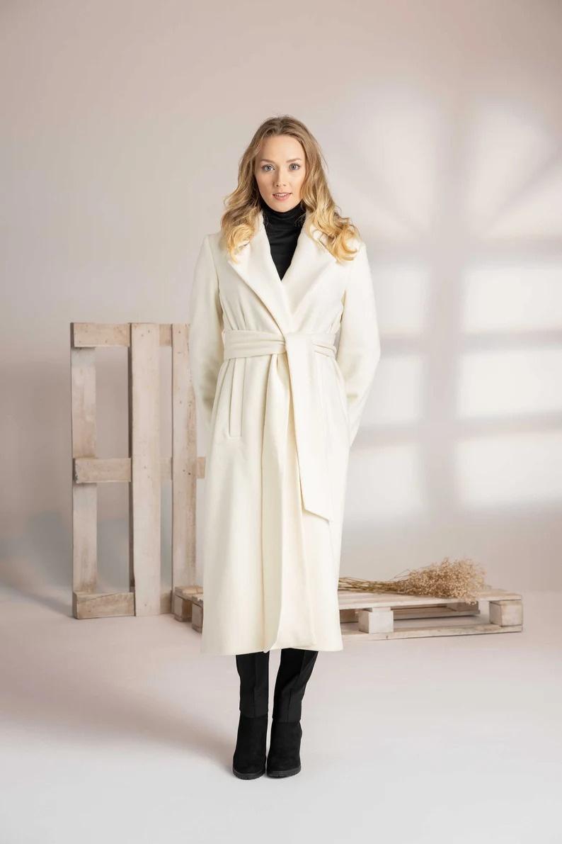Belted White Wool Coat Over Black Turtleneck — Winter White Outfits