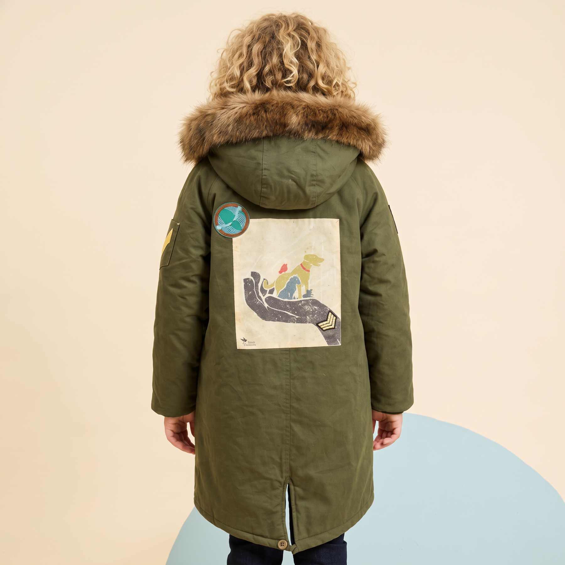 Olive Parka with Graphic Back Print Over White Shirt and Dark Jeans — Parka Outfits