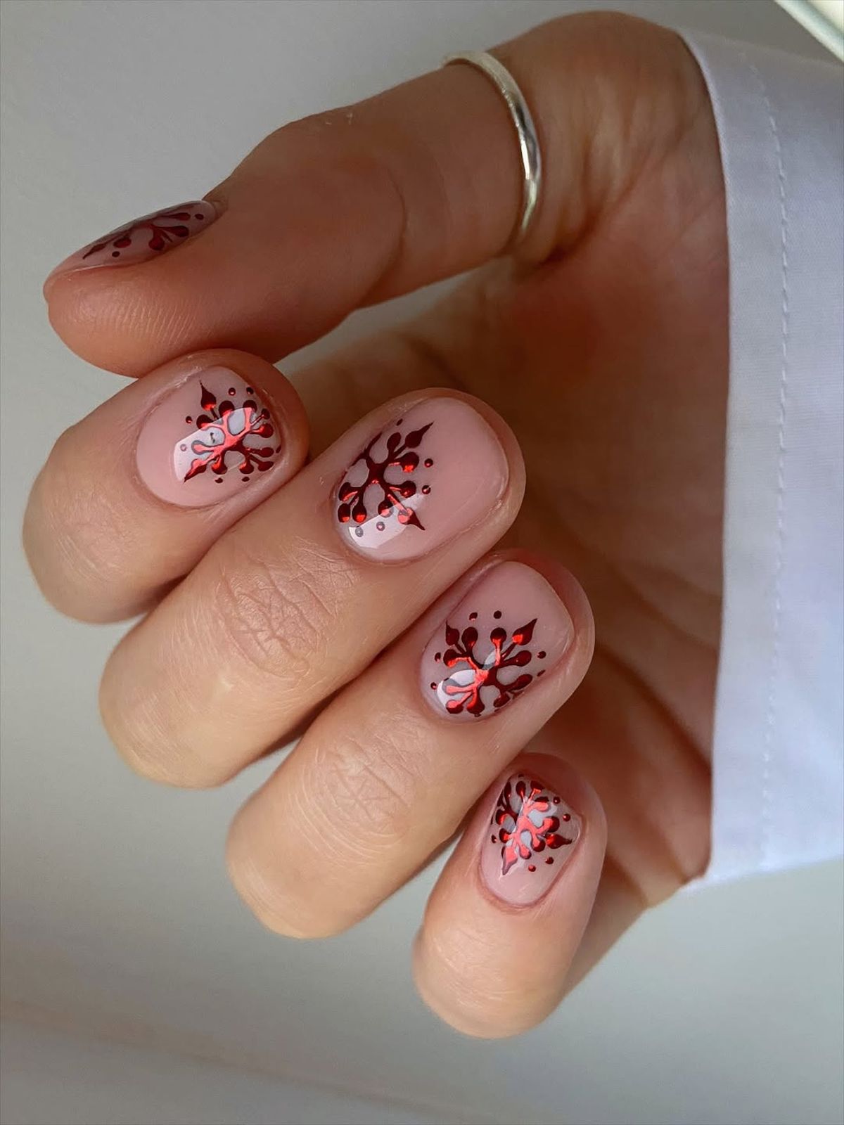Sheer Nude Nails with Snowflake Art — Christmas Nail Designs 2026