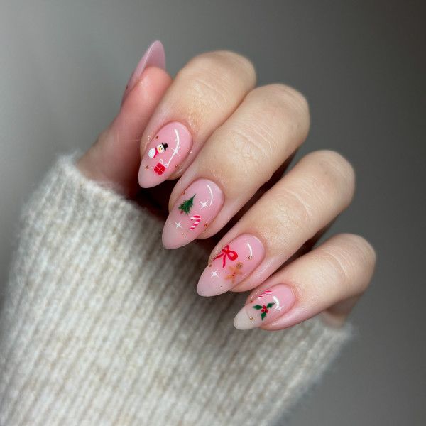 Sheer Pink Festive Motifs Almonds Sheer Pink Festive Motifs Almonds β Subtle Christmas Nails 2026