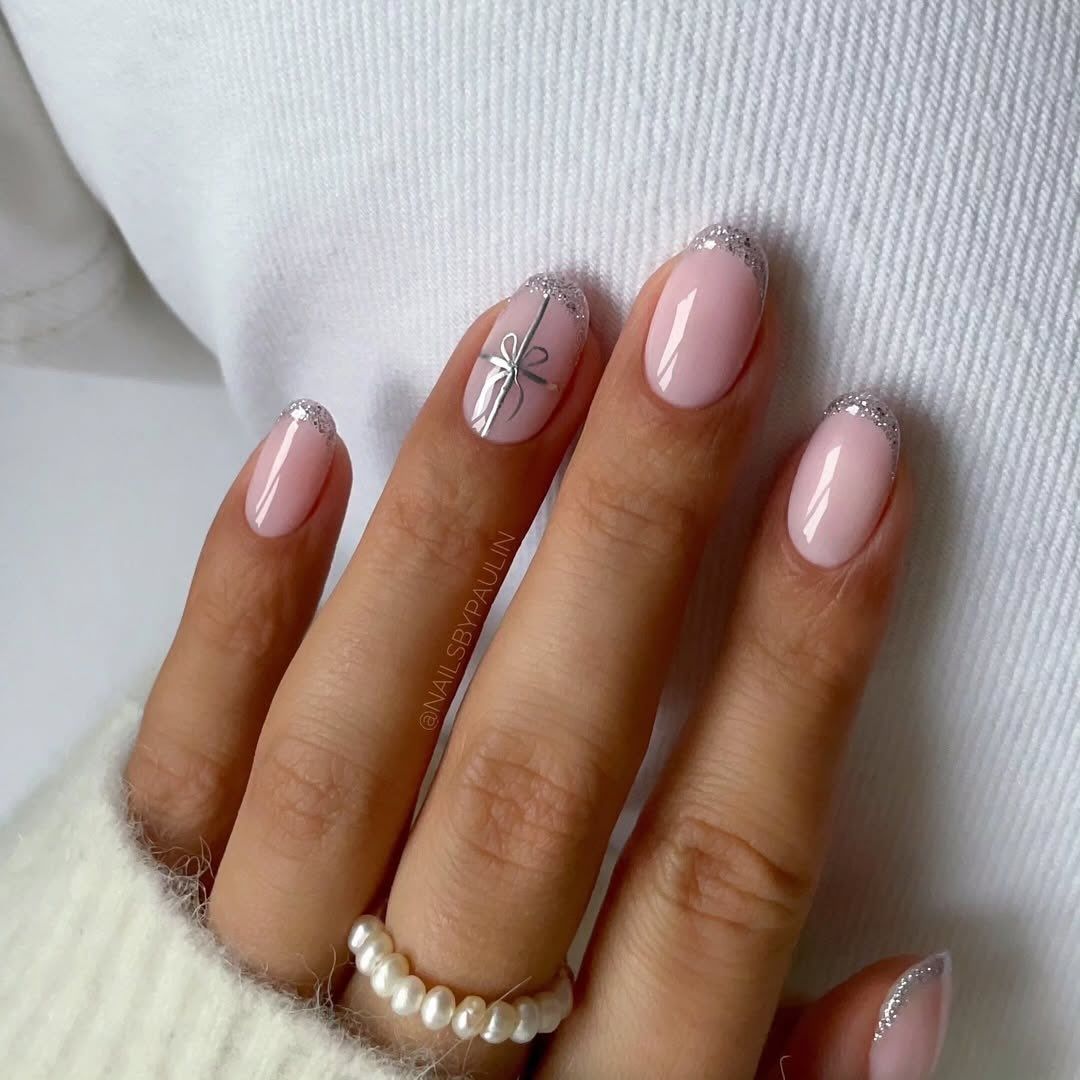 Silver Glitter French Tips with Bow Detail Silver Glitter French Tips with Bow Detail β Short Christmas Almond Nails 2026