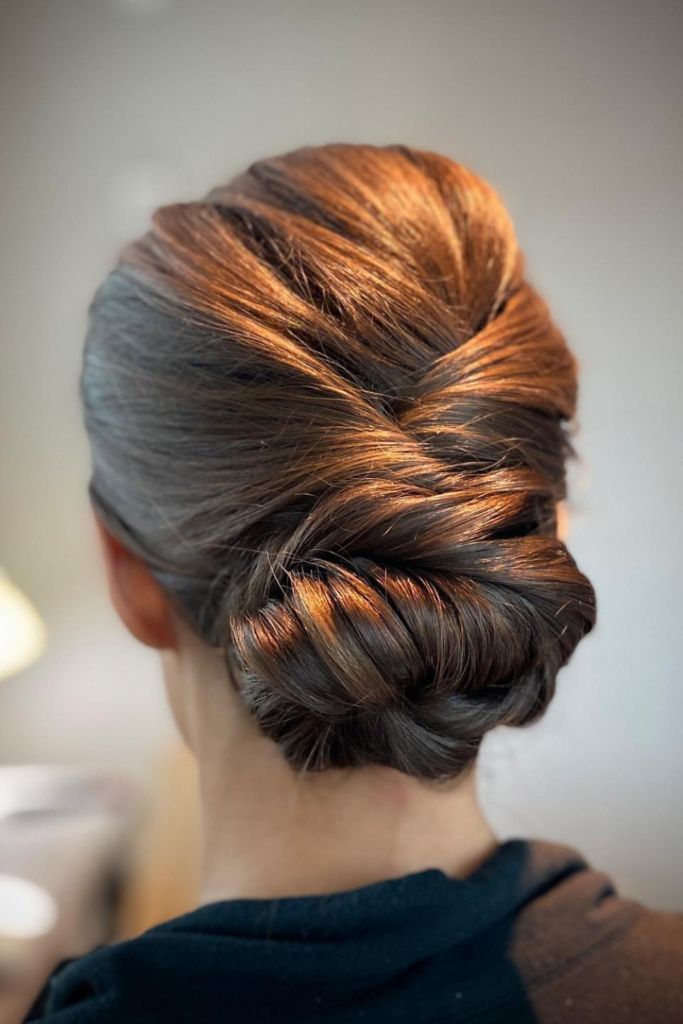 Twisted Low Bun With Auburn Highlights — Winter Hairstyles for Thick Hair