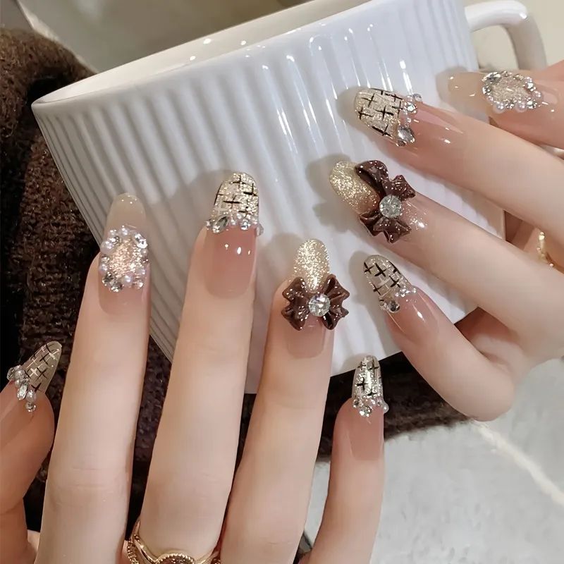 Nude French With 3D Bows and Rhinestones Nude French With 3D Bows and Rhinestones β Winter Rhinestone Nails